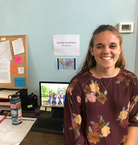 caroline in front of her desk