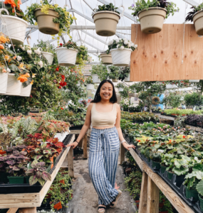 Phoebe surrounded by plants