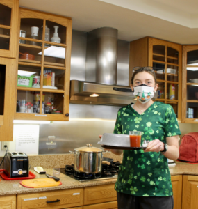 Kasia Kwitnieski Blog 2 holding up a food tray in the kitchen at Francis House