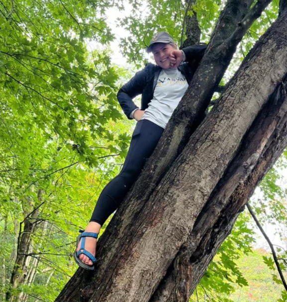RaeAnn Kirk climbing in a tree