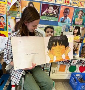 Lucy sitting down reading a story