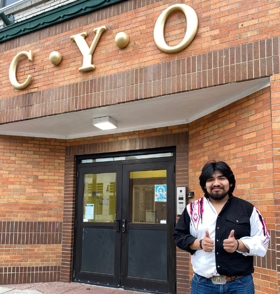 Photo of Cristo Castillo in front of his service site, CYO