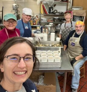 Photo of Haley Buckbee with Assumption Food Pantry and Soup Kitchen volunteers.